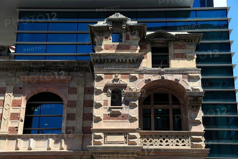 Romania, capital Bucharest, Bucuresti, House of the Union of Romanian Architects, The building is known for its distinctive architectural combination of old and new, with a modern glass tower rising from the ruins of a historic house, the original Paucescu House building was built around 1880 in the French Renaissance style and was severely damaged during the Romanian Revolution of 1989