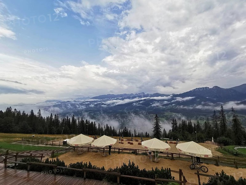 Mountain panorama with clouds, conifers and leisure area, huts and wide sky, Gubalowka, Zakopane, hiking in the High Tatras National Park, Carpathian Mountains, Poland