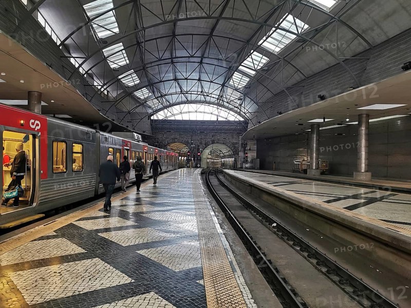 A modern train station with open roofs where trains arrive and people travel, Lisbon railway station, Portugal