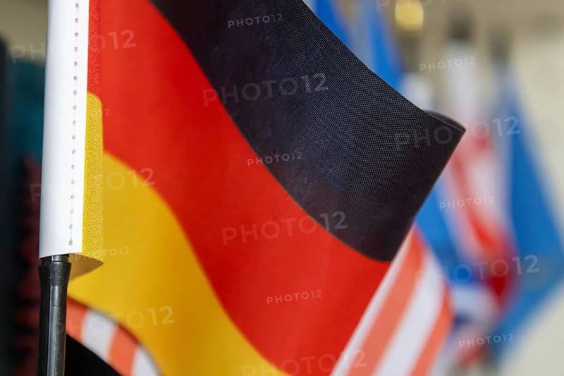 Close-up of a German flag in front of other flags (USA, Europe etc.)
