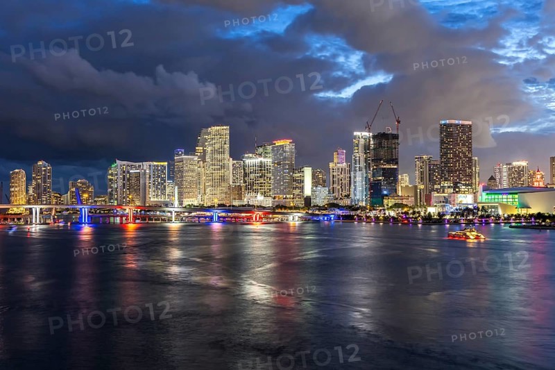 Miami skyline with high-rise real estate in downtown by the ocean at night in Miami, USA