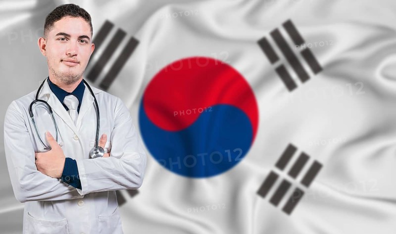 Portrait of medical professional on South Korea flag background. South Korean national health system