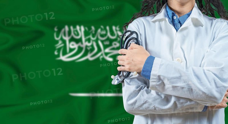 Healthcare professional with Saudi Arabia flag background. Professional doctor holding stethoscope on Saudi Arabia flag background