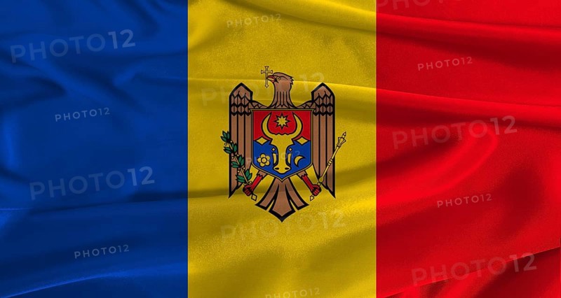 Flag of Moldova with fabric textured background. Close up of National flag of Moldova with realistic texture