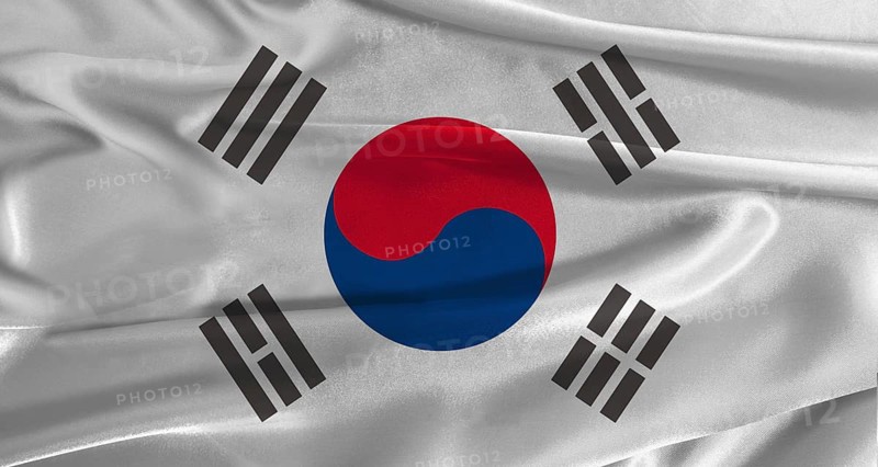 Flag of South Korea with fabric textured background. Close up of National flag of South Korea with realistic texture