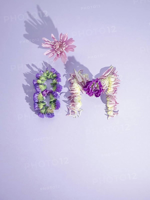 Flowers forming the 8m symbol on a purple background representing international women's day