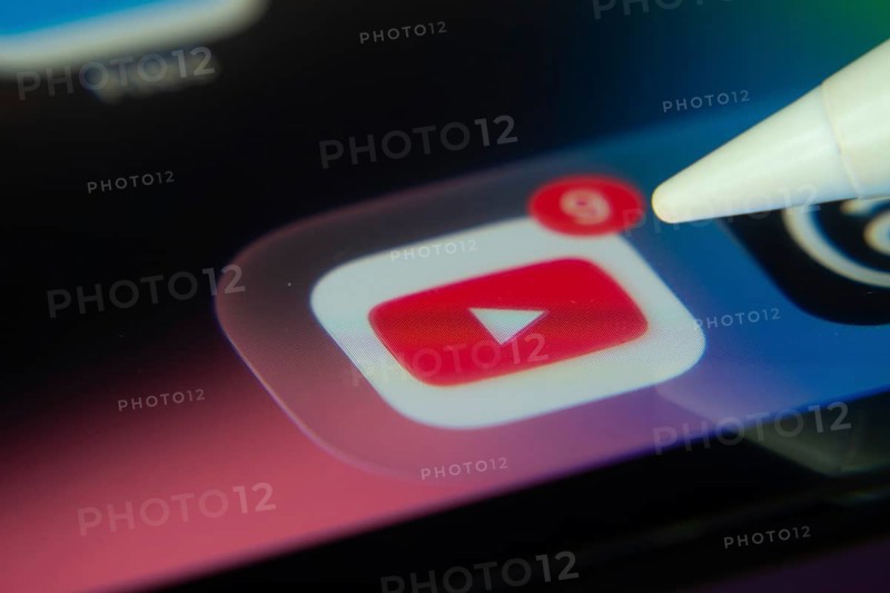 16 Nov 2025- Dhaka, Bangladesh: Stylus touching the youtube app icon with a notification on a smartphone screen
