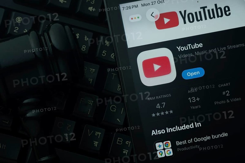 Dhaka, Bangladesh- 28 Oct 2025: An iPad displaying the youtube app against a judge's gavel and dark keyboard background