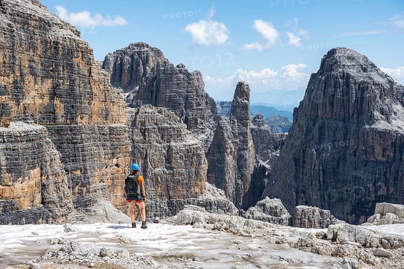 Hikers on the Sentiero Brentari hiking trail in front of cliffs, Brenta Mountains, Brenta-Adamello Natural Park, Trentino, Italy