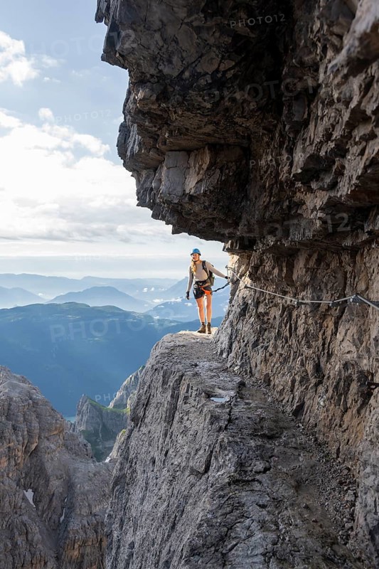 Climbers on a rock band, Bocchette Centrale band trail, via ferrata in the Brenta Mountains, Brenta-Adamello Natural Park, Trentino, Italy