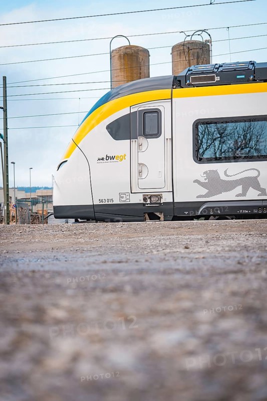 Partial view of a modern locomotive next to industrial structures, opening of the Hermann Hesse Railway, Calw, Germany