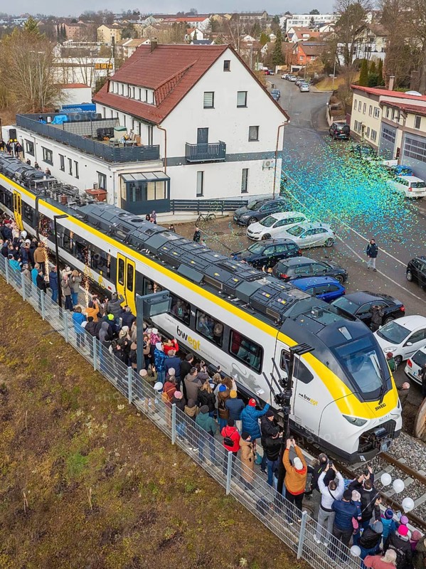 Train surrounded by a crowd in an urban area, aerial view, opening of the Hermann Hesse Railway, Calw, Germany