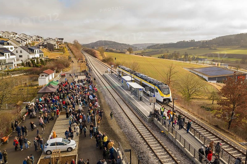 A lively train station in a rural area with lots of people, trains and an idyllic landscape, opening of the Hermann Hesse Railway, Calw, Germany