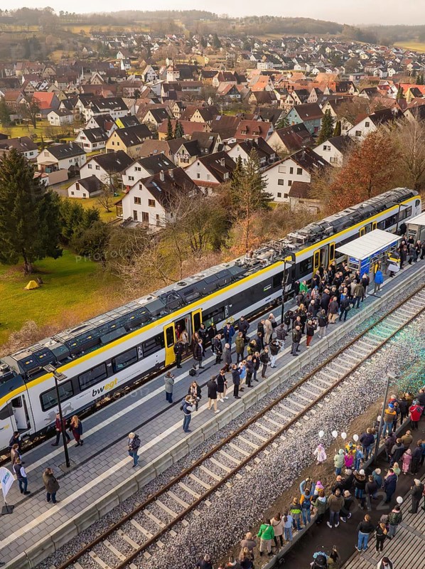 Train in rural areas stops along the platform with numerous observers, opening of the Hermann Hesse Railway, Calw, Germany
