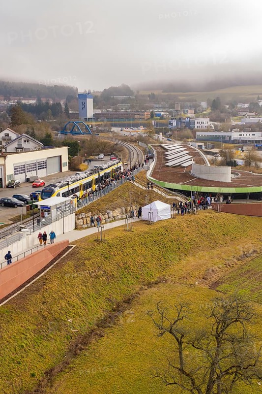 A large crowd gathers at a station area in a hilly landscape, opening of the Hermann Hesse Railway, Calw, Germany
