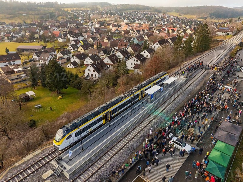 A train on a platform in a village, surrounded by a large crowd, opening of the Hermann Hesse Railway, Calw, Germany