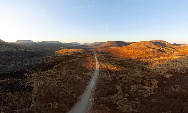 Aerial view, road leading through dry desert landscape, hills in Damaraland, Namibia