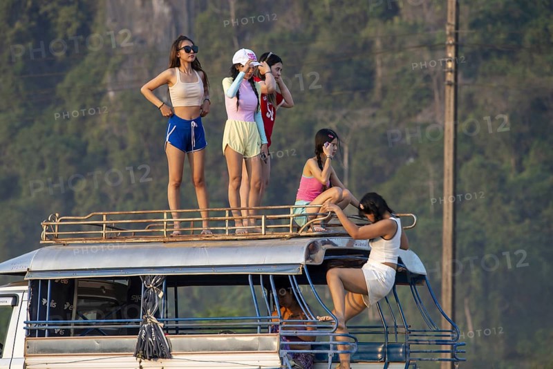 Photo shoot with young girls in the karst landscape near Vang Vieng, Vientiane province, Laos