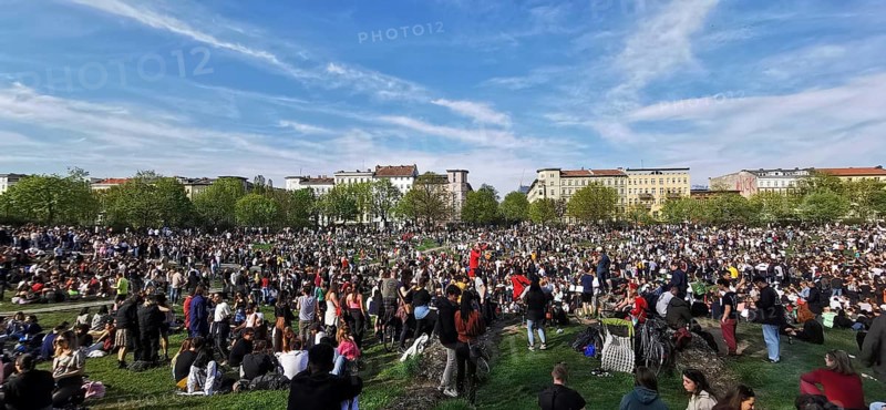 May 1, public holiday, Labor Day in Görlitzer Park in Berlin, many people sitting relaxing on the meadow under a blue sky, panorama, Berlin