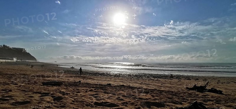 A quiet beach with bright sunshine and light surf, Morocco