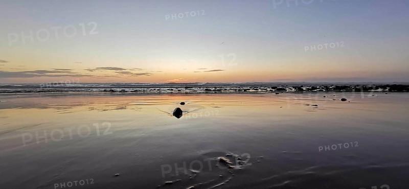 Evening on the beach with soft waves and peaceful horizon, Morocco