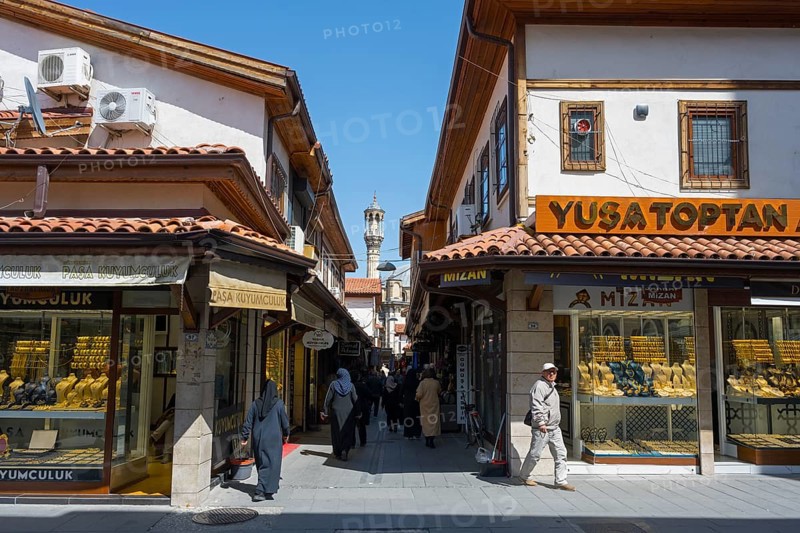 Lively market street with traditional shops and passers-by on a sunny day, jewelry shops, Konya, Central Anatolia, Turkey