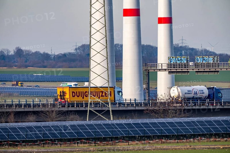 86.5 MW peak open space photovoltaic systems, from RWE, with over 141, 000 solar modules, on a side strip, over 1 km long, along the A44 motorway near Bedburg, at the Jackerath triangle, recultivated open-cast mining site, wind farm north of Titz, North Rhine-Westphalia, Germany