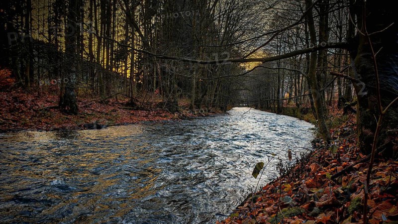Romantic river landscape at dusk with autumnal atmosphere and calm water, Franconian Forest, Germany