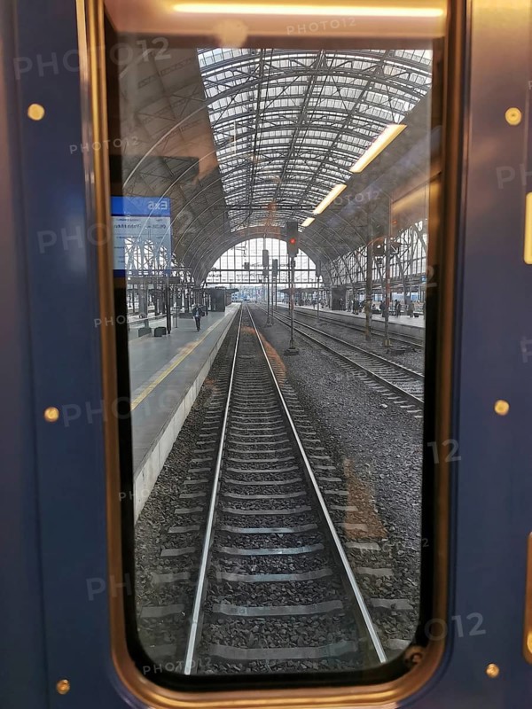 View from train window of abandoned train tracks in the train station, Prague