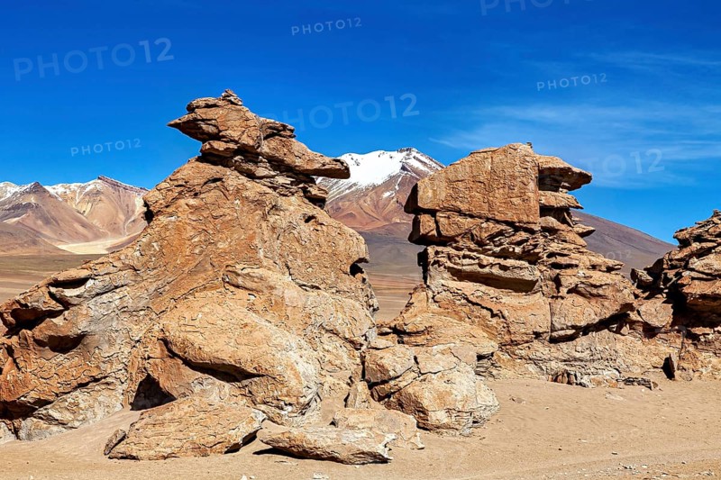 Majestic rock formations in a vast, barren desert landscape under blue skies, The Altiplano landscape in Bolivia