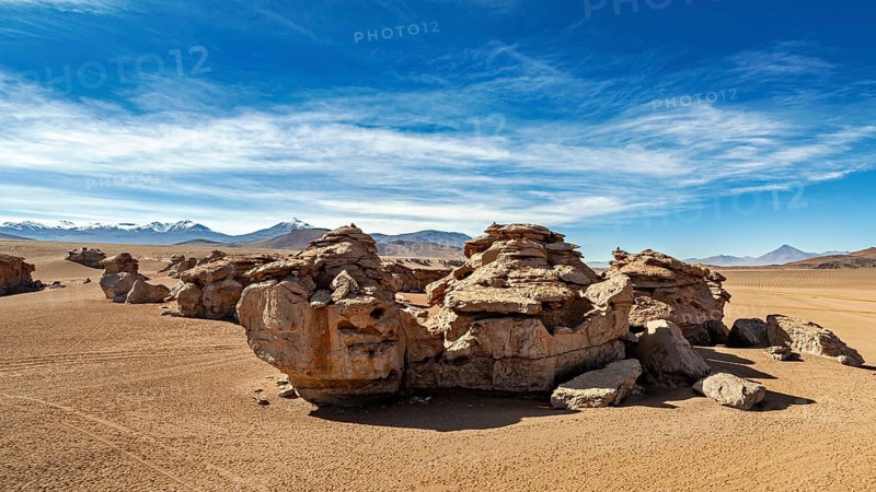 Impressive rock formations in a sandy desert landscape under clear skies, The landscape of the Altiplano in Bolivia