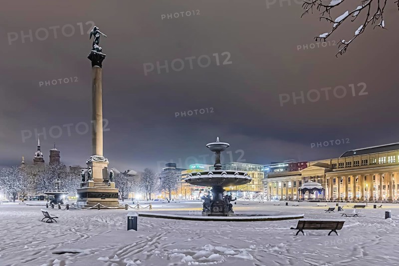Winter in Stuttgart. It snowed overnight and the city is wintry white early in the morning. Palace Square with anniversary column, royal building and art museum. Stuttgart, Baden-Württemberg, Germany