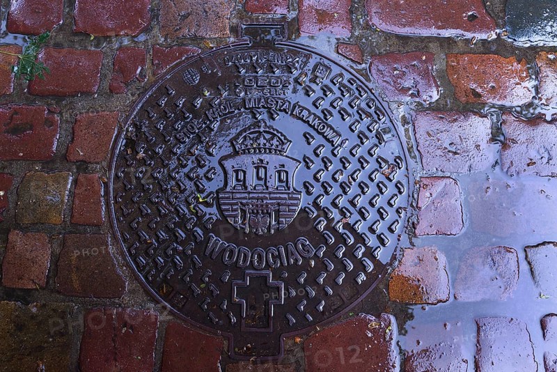 Manhole cover with the coat of arms of Krakow, Krakow, Poland