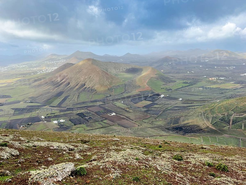 View of Montaña Tesa volcano from Montaña Blanca mountain with cloudy sky, Lanzarote, Canary Islands, Spain