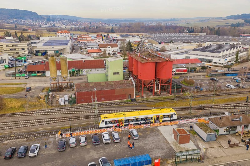 Aerial view of an industrial area with yellow train and large building structures, acceptance of the Hermann Hesse Railway, Weil der Stadt, Black Forest, Germany