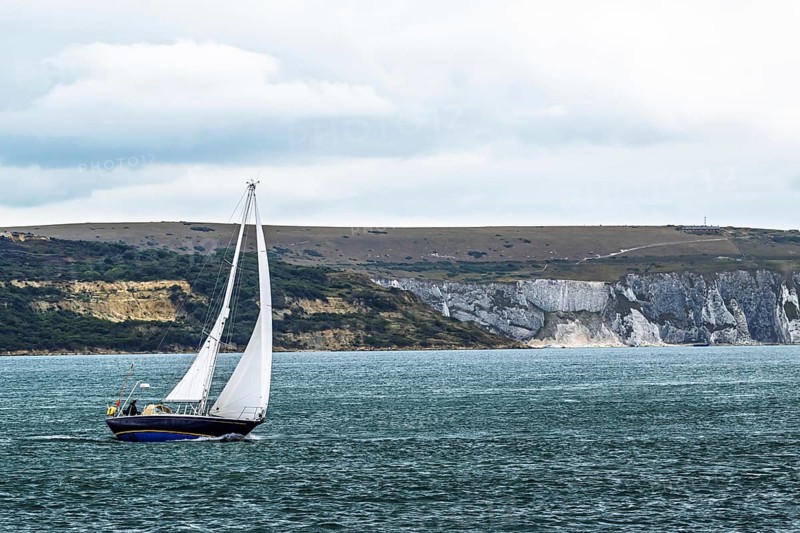 Boats over Hurst Point Lighthouse and Hurst Castle, Hurst Spit, Milford on Sea, Lymington, Hampshire, UK