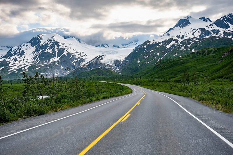 Road through mountain landscape, picturesque landscape with Worthington glacier, dramatic cloudy sky, Richardson Highway, Alaska, USA