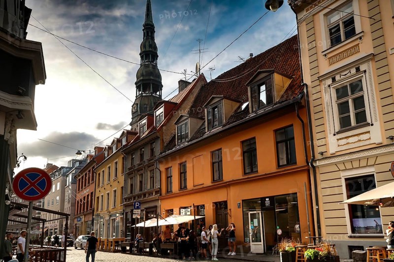 Street view with St. Peter's Church and adjacent colorful architecture in Riga, Riga, Latvia