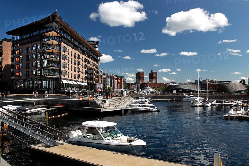 Harbour view of Tingvallakaja with modern buildings and boats under blue sky, Oslo, Norway