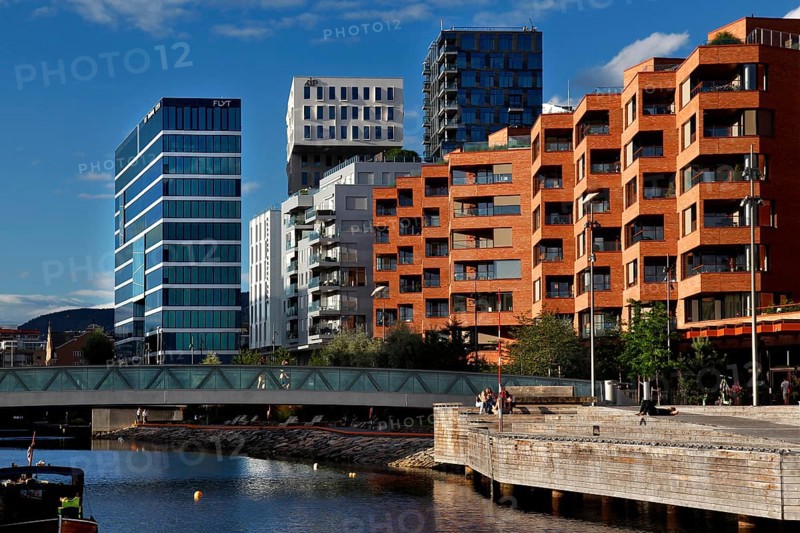 Colourful modern facades along the water in bright blue sky, Oslo, Norway