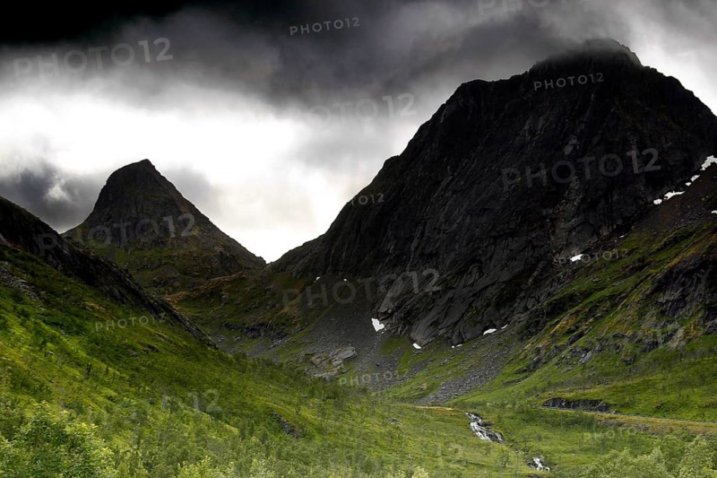 Dramatic mountain scenery under gloomy sky in Bergsbotn, Senja, Norway