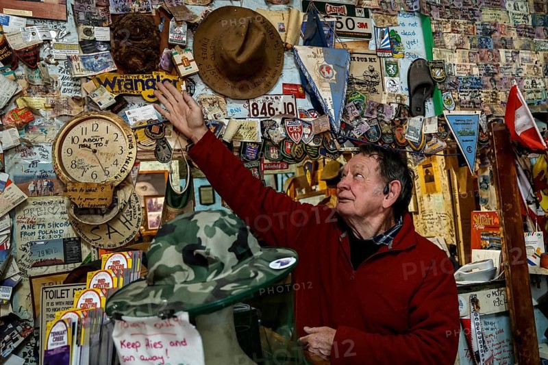 Person touches hat wall at Barrow Creek Hotel, Barrow Creek, Australia
