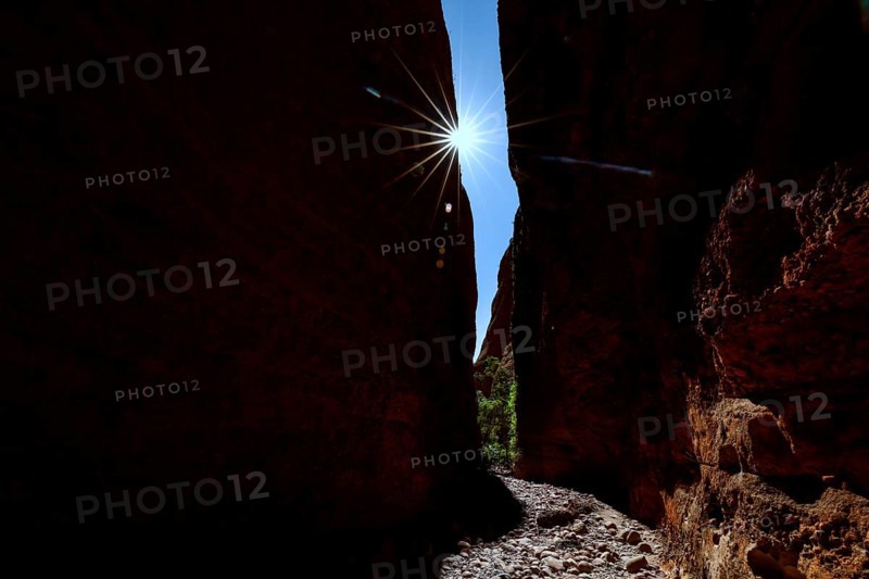 Light sweeps through the narrow Echidna Chasm and illuminates the rough rock walls, Purnululu, Western Australia, Australia