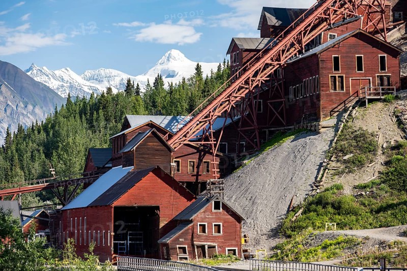Red Kennicott buildings in front of mountainous landscape, Kennicott Concentration Mill to extract copper from quarried rock, Historic Kennecott Copper Mine, National Historic Landmark, Wrangell St. Elias National Park, Alaska, USA
