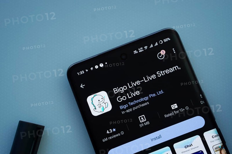 Dhaka, Bangladesh- 29 May 2025: On a blue surface, a smartphone displays the Bigo Live app within the Google Play Store