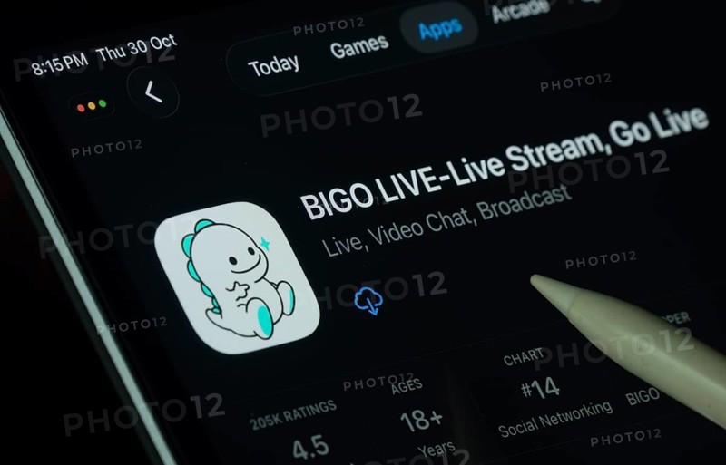 Dhaka, Bangladesh- 30 Oct 2025: Bigo Live app displayed on a iPad screen in dark mode with a digital pen pointing at it
