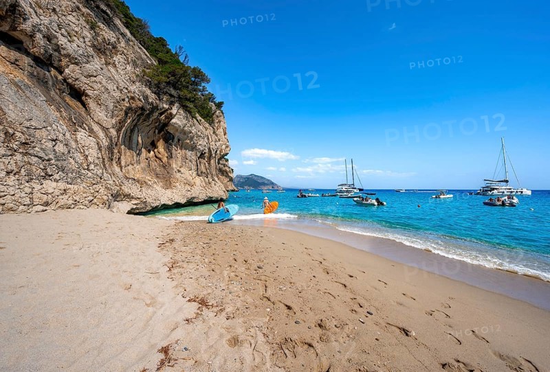 Sandy beach beach and steep cliffs at Cala Luna, Golfo di Orosei, Baunei, Sardinia, Italy
