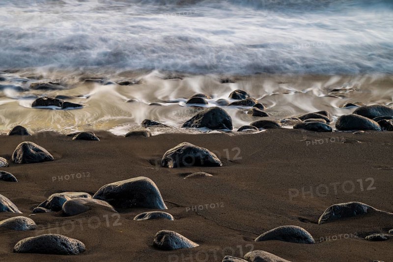 Sunset, waves and rocks in the sea, Praia Formosa, Madeira, Portugal