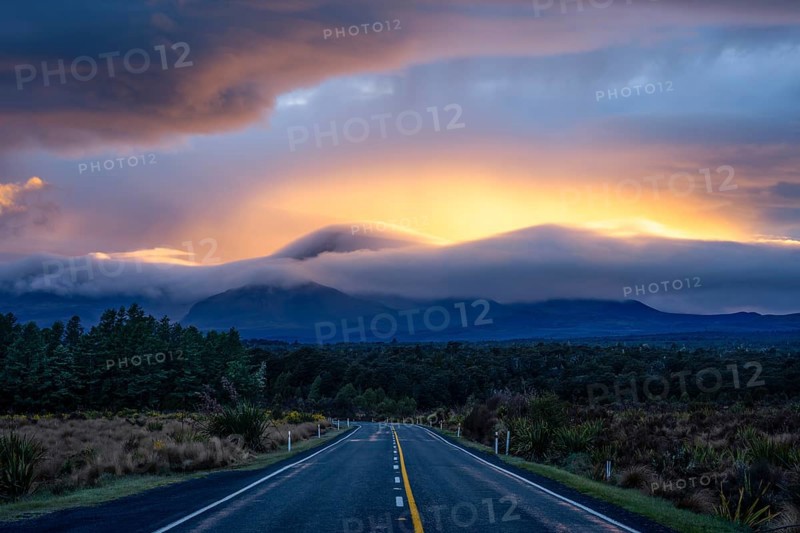 Mount Ngauruhoe in the morning at sunrise with glowing clouds, road SH 47. Tongariro National Park, North Island, New Zealand