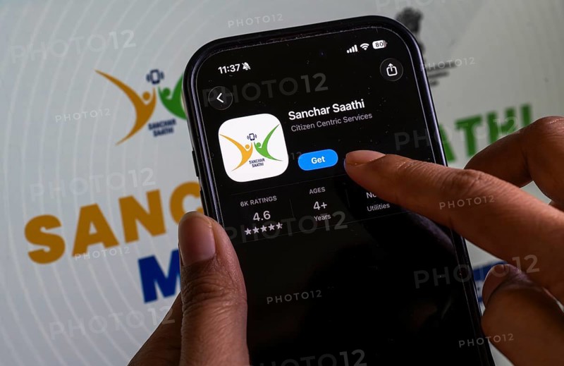 In this photo illustration, a person downloads the Sanchar Saathi mobile application on an iPhone, in New Delhi, India on 3 December 2025. Sanchar Saathi is officially developed and operated by the Department of Telecommunications (DoT), Government of India as part of its citizen-protection and telecom-security initiative